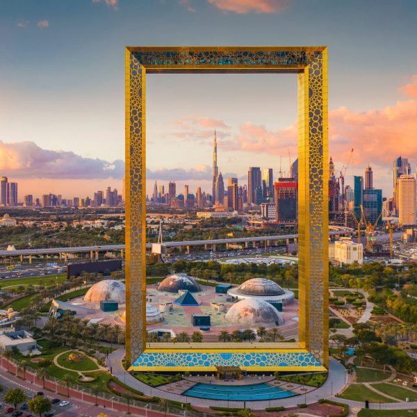 Aerial view of Dubai Frame, Downtown skyline, United Arab Emirates or UAE. Financial district and business area in smart urban city. Skyscraper and high-rise buildings at sunset.